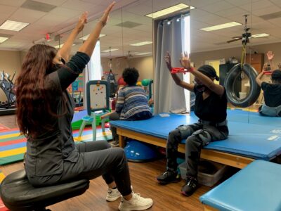 Occupational Therapist does exercise with patient