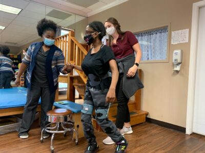 physical therapist help patient walk
